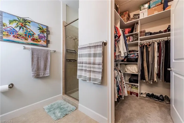 Spacious closet with light tile patterned floors