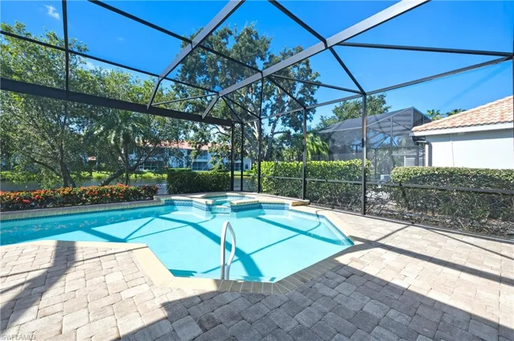 Screened lanai featuring a swimming pool and integrated spa