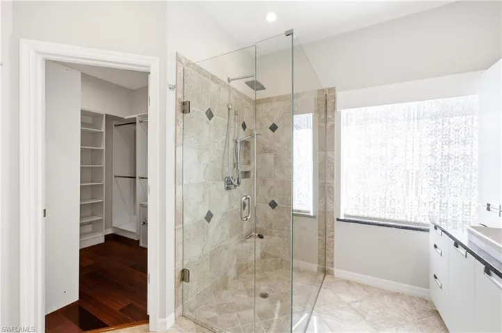 Spacious Master walk-in shower with glass enclosure and tiled walls