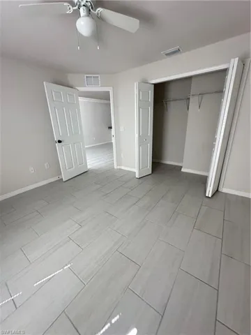 Unfurnished bedroom with a closet and a ceiling fan