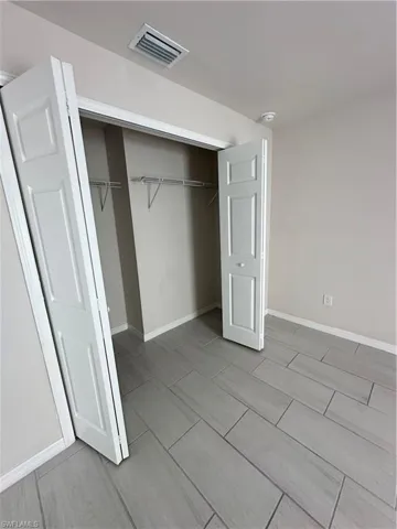 Unfurnished bedroom featuring a closet and wood tiled floors