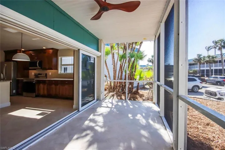 Sunroom / solarium featuring ceiling fan
