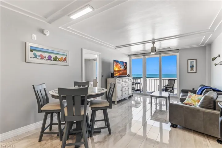 Dining room featuring floor to ceiling windows and baseboards