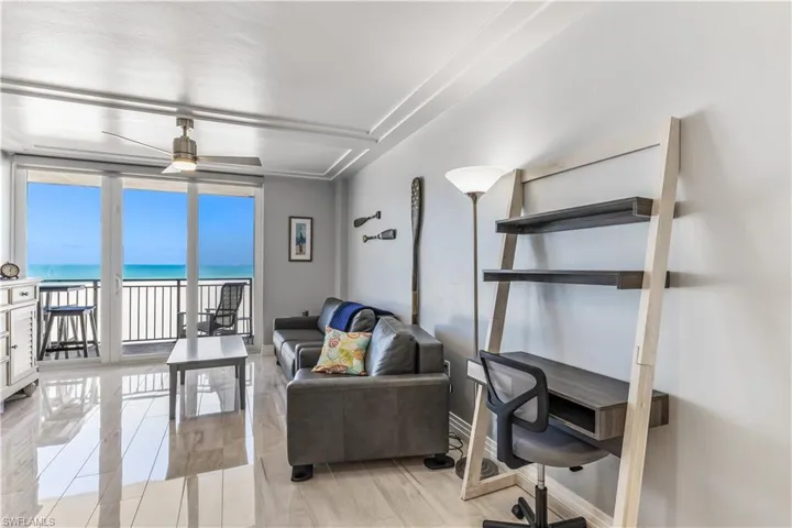 Living area with a water view and a ceiling fan