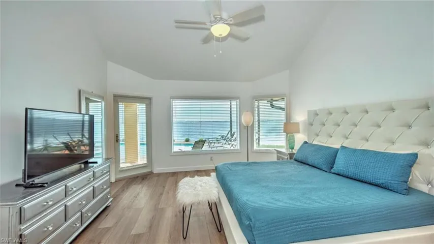 Master Bedroom featuring vaulted ceiling, light wood-type flooring, a ceiling fan, and access to outside