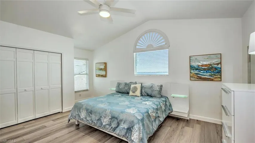 Guest Bedroom upstairs featuring light wood-type flooring, lofted ceiling, a closet, and ceiling fan