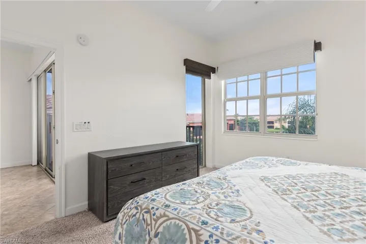Tiled bedroom featuring ceiling fan