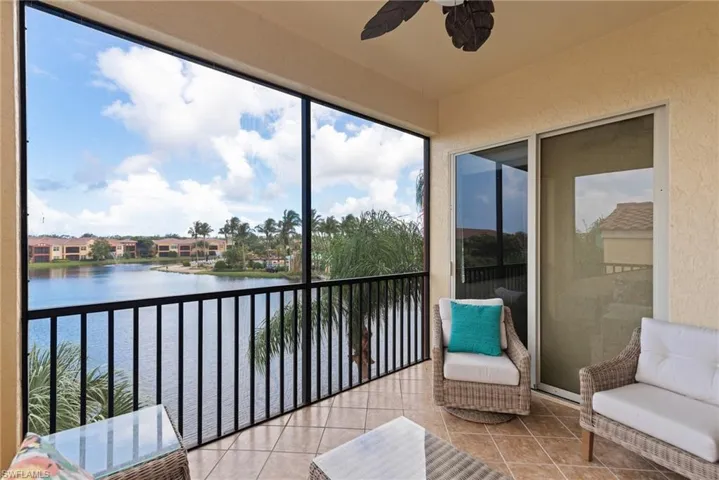 Sunroom / solarium featuring a water view and ceiling fan