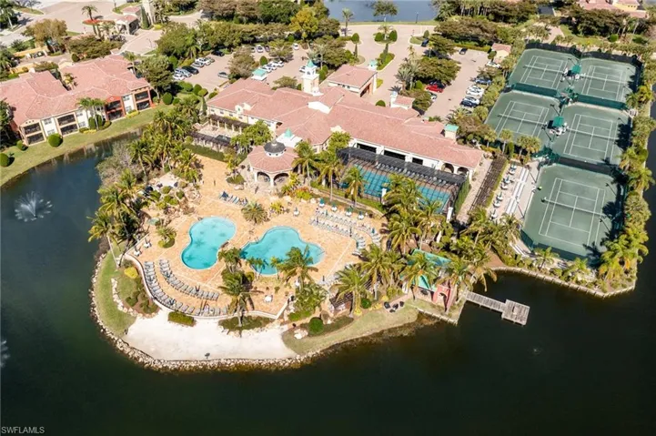 Birds eye view of property with a water view