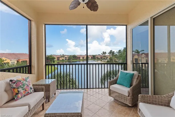 Sunroom / solarium featuring a water view and ceiling fan
