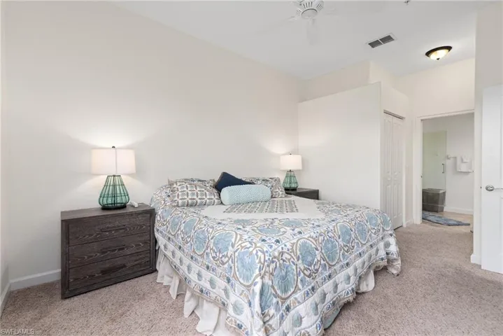 Bedroom featuring a closet, ceiling fan, and light colored carpet