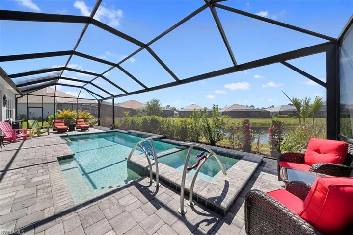 This property features a screened-in lanai with a swimming pool and an integrated spa
