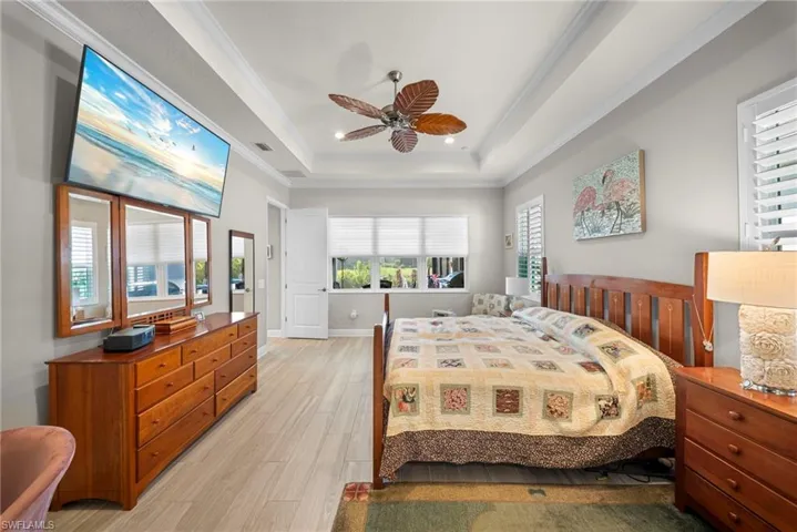 The property features light-colored flooring, a tray ceiling, and a ceiling fan