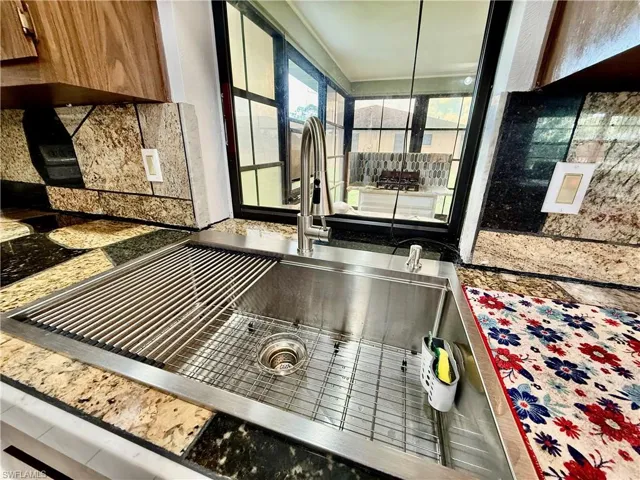 Large sink with cutting board.
