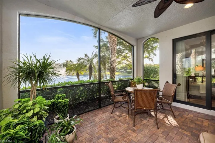 Sunroom / solarium featuring a water view, plenty of natural light, and ceiling fan