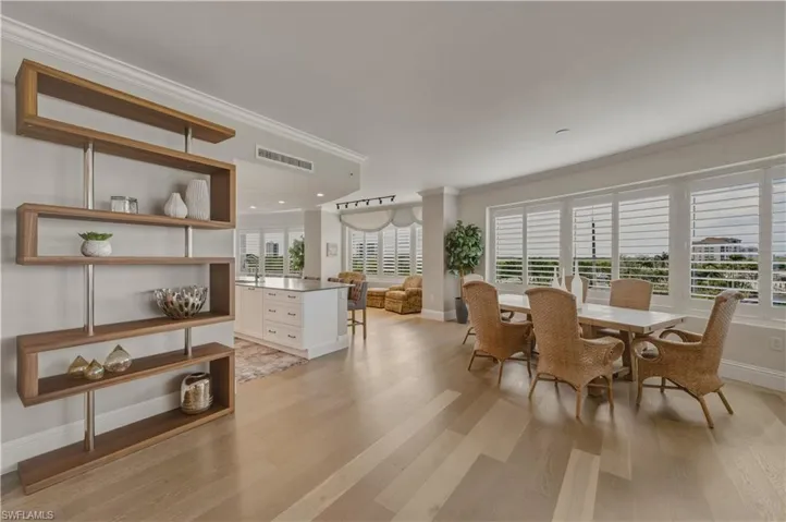 Dining room with crown molding and light wood-type flooring
