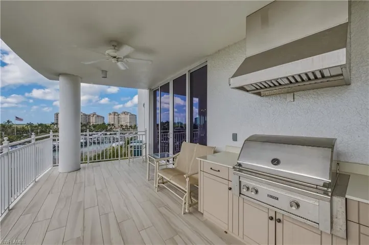 Deck featuring a grill, ceiling fan, and a patio area