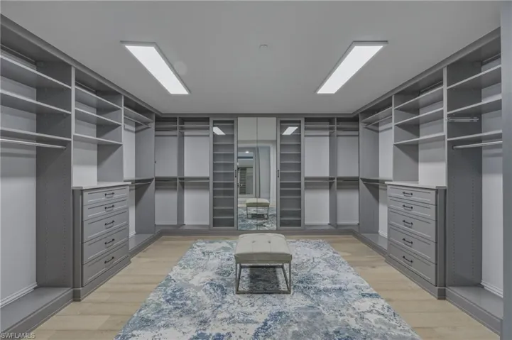 Walk in closet featuring light wood-style flooring