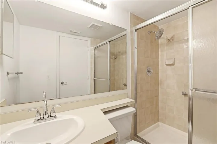 Bathroom featuring vanity and a stall shower