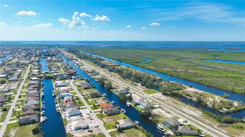 Aerial perspective showcasing a canal-front community with a vast natural preserve and waterway system