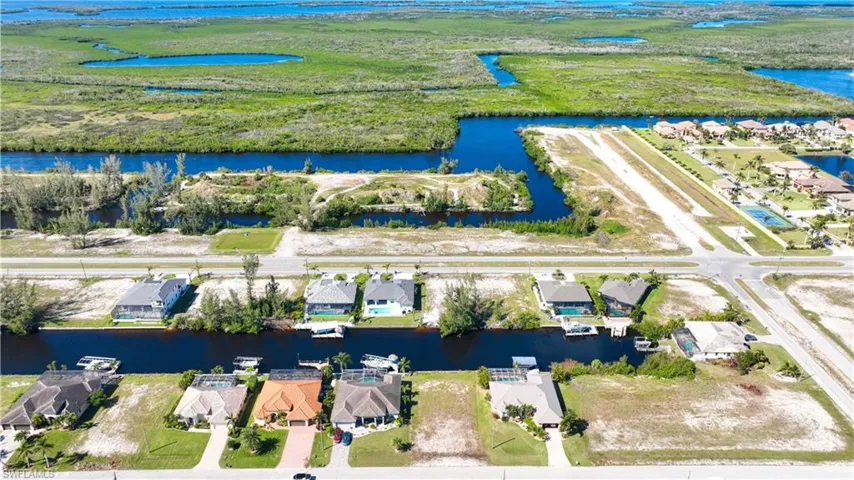 Aerial depiction of a residential area featuring canal-front properties