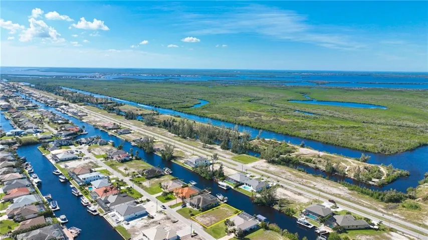 Waterfront parcel with direct canal access, surrounded by established residential properties and undeveloped natural areas