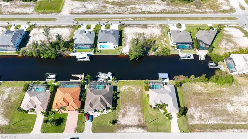 Aerial perspective showcasing a canal-front property with a private dock