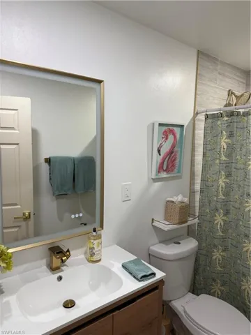 Bathroom with vanity and curtained shower