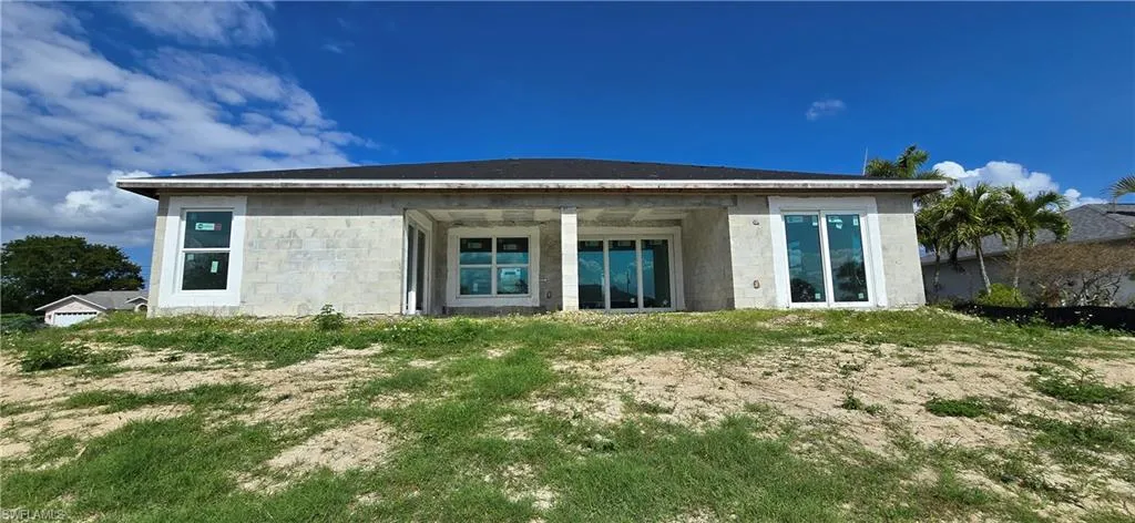Rear view of property featuring concrete block siding