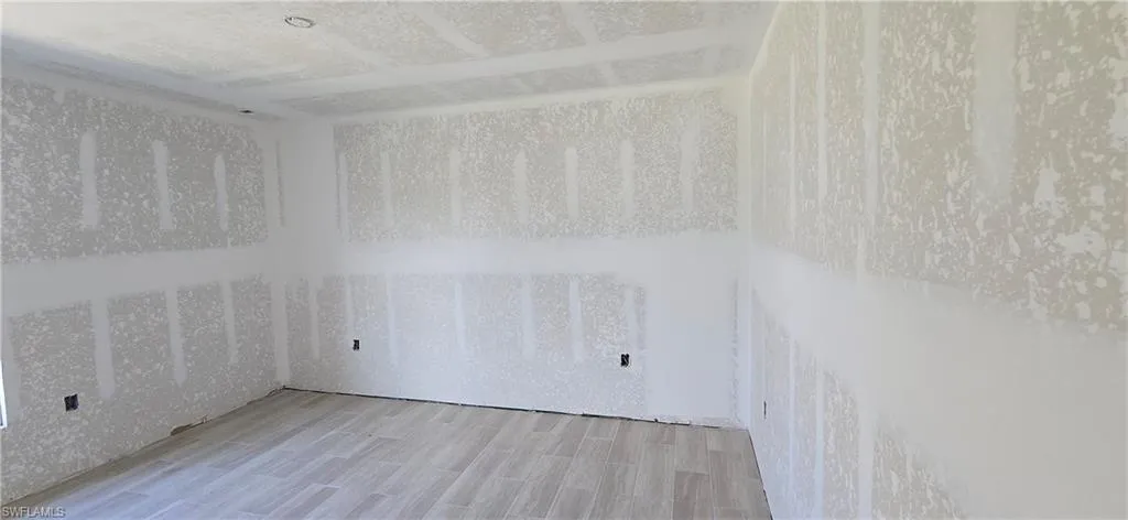 Unfurnished room with wood finished floors
