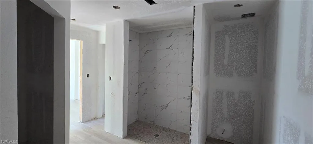 Bathroom featuring a marble finish shower