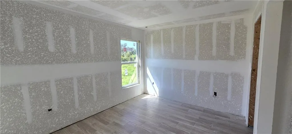 Spare room with wood finished floors