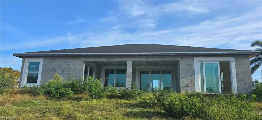 Back of house with stone siding
