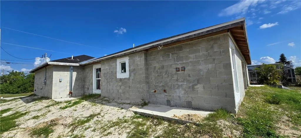 Rear view of house featuring concrete block siding