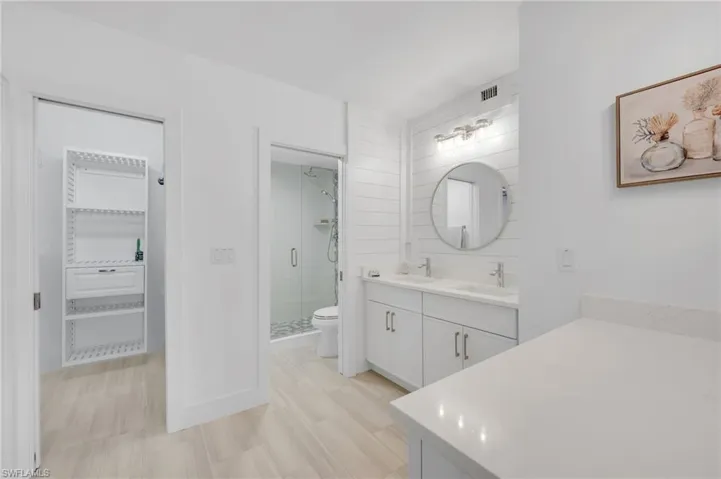 Dual sinks, beautiful tile shower and walk in closet