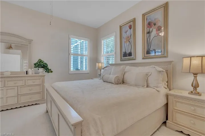 Bedroom featuring light carpet