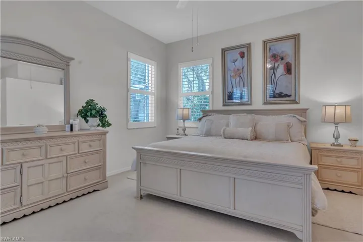 Bedroom featuring light colored carpet and baseboards