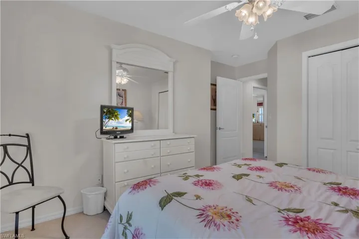 Bedroom with a closet, a ceiling fan, and baseboards