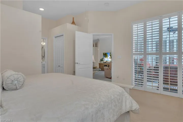Carpeted bedroom featuring ensuite bath
