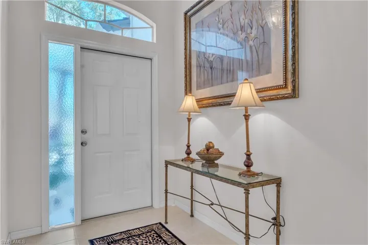 Entryway with baseboards and tile patterned flooring
