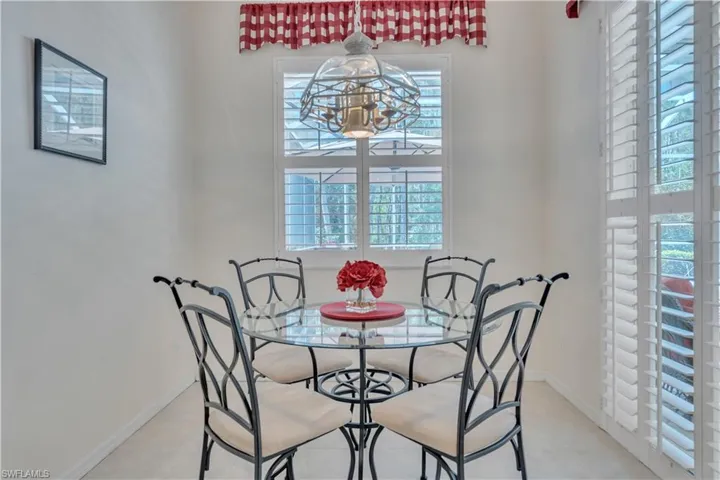 Dining area with plenty of natural light, a chandelier, and baseboards