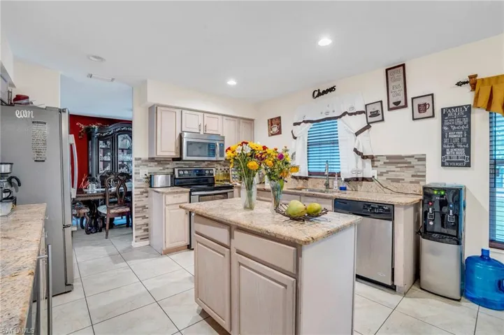 Kitchen featuring tasteful backsplash, stainless steel appliances, and a kitchen island