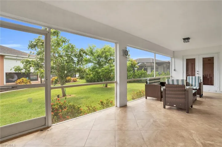 Sunroom / solarium featuring french doors and a healthy amount of sunlight
