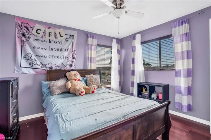 Bedroom featuring ceiling fan and dark hardwood / wood-style floors