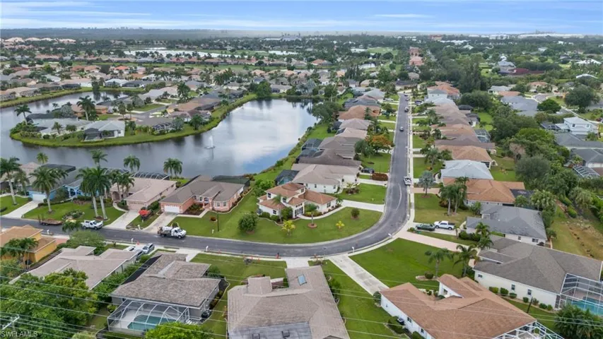 Birds eye view of property with a water view