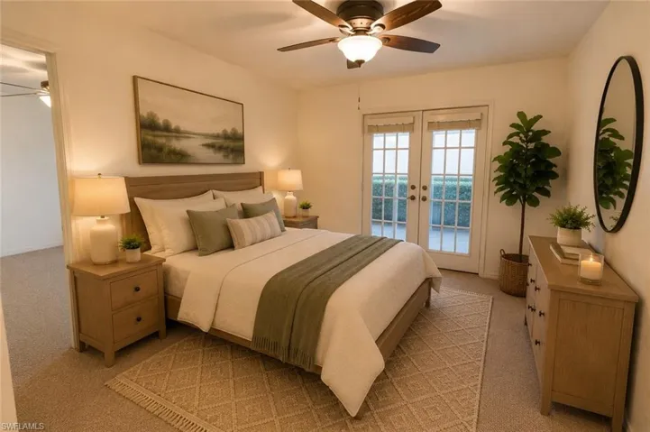 Carpeted room featuring a ceiling fan with integrated lighting, wood-finish headboard, and French doors