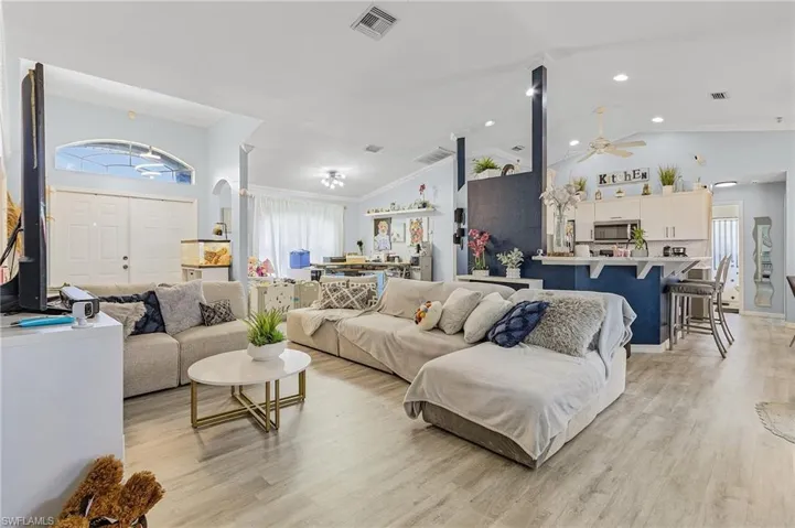 Living room featuring plenty of natural light, ceiling fan, and light hardwood / wood-style floors