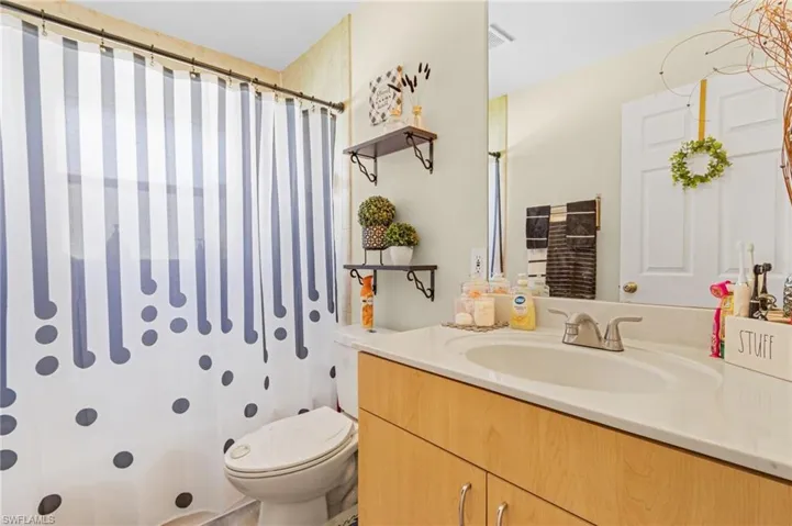 Bathroom with oversized vanity and toilet