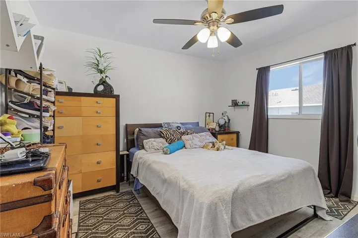 Bedroom featuring dark hardwood / wood-style floors and ceiling fan