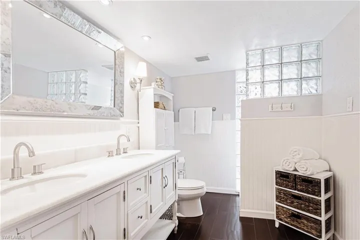 Bathroom with vanity, hardwood / wood-style flooring, and toilet